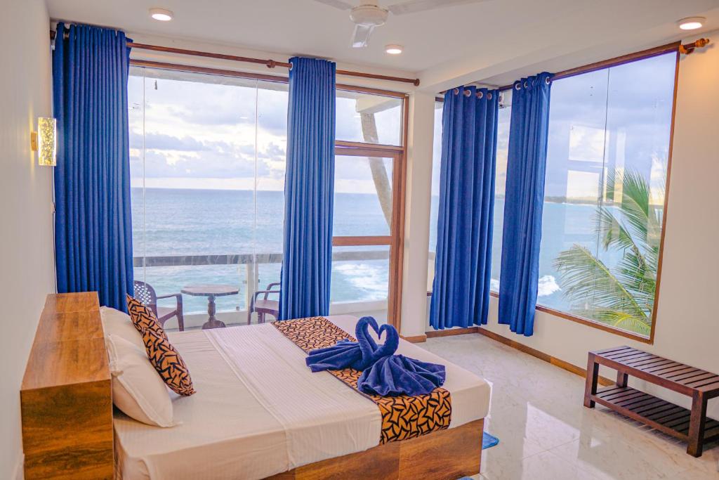 Ένα ή περισσότερα κρεβάτια σε δωμάτιο στο Cool Beach Hotel