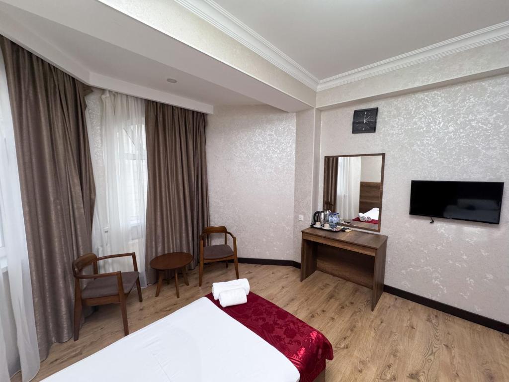 Postel nebo postele na pokoji v ubytování Consul Hotel
