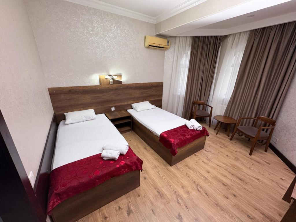 Postel nebo postele na pokoji v ubytování Consul Hotel