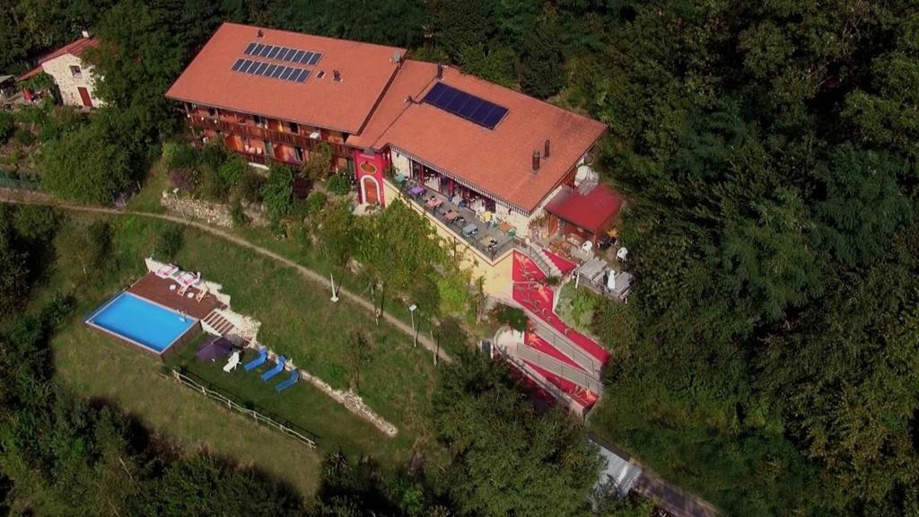 an aerial view of a building with a swimming pool at Eco Hotel Locanda del Giglio in Roveredo Capriasca