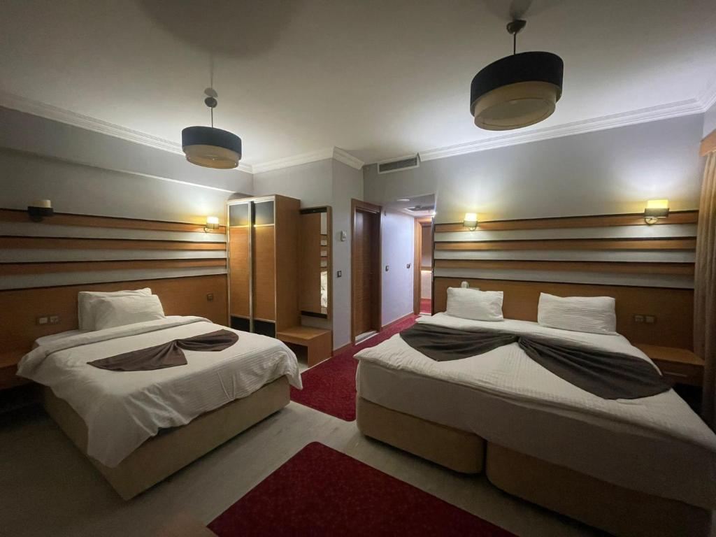 A bed or beds in a room at Quars Garden Hotel