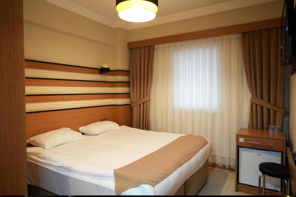 A bed or beds in a room at Quars Garden Hotel