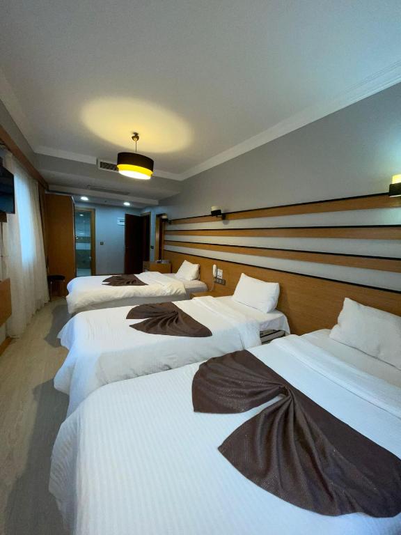 A bed or beds in a room at Quars Garden Hotel