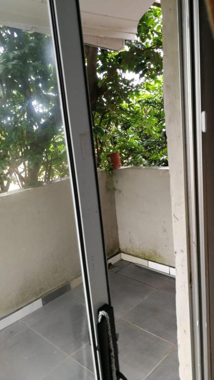a sliding glass door with a view of a balcony at Tongaat beach holiday rental in Densainagar
