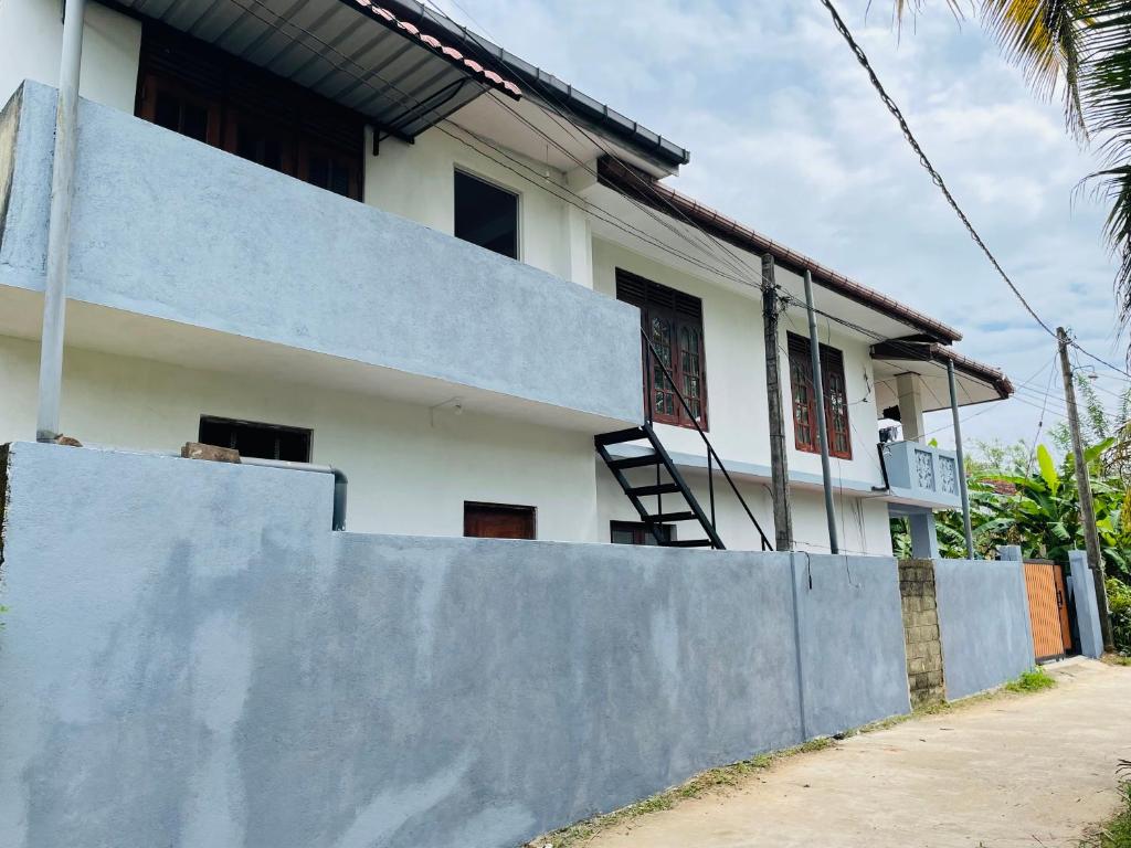 a house with a fence in front of it at TM Villa Madiha in Matara