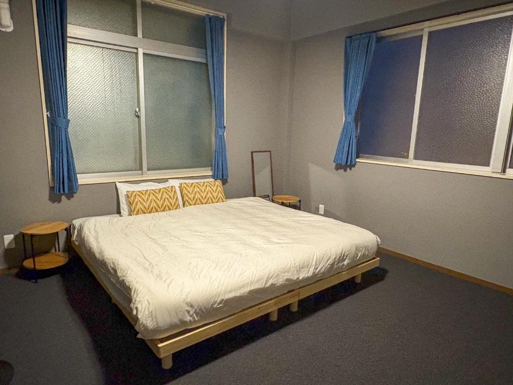 Postel nebo postele na pokoji v ubytování Guest House Umikaji