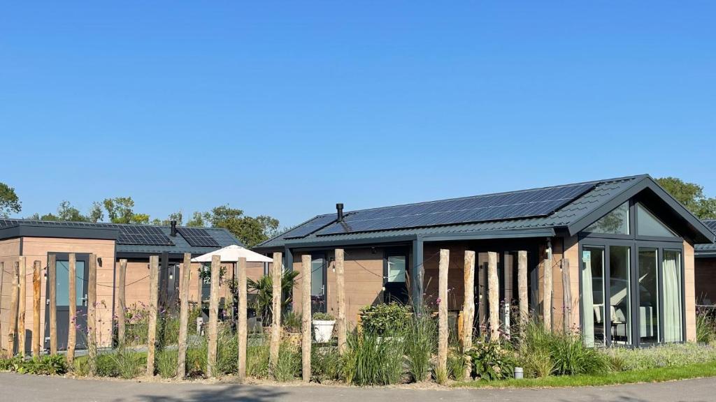 a house with solar panels on the side of it at Huisje in Dishoek in Koudekerke
