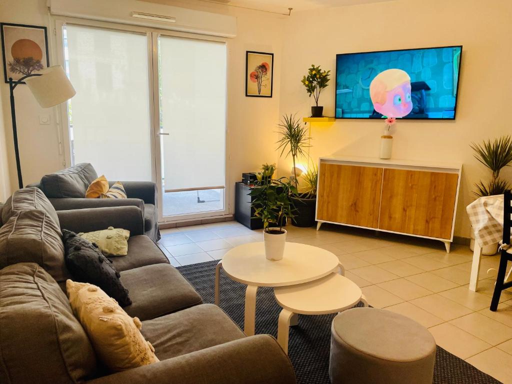un salon avec un canapé et une télévision dans l'établissement T3 récent avec terrasse et parking, à Marseille