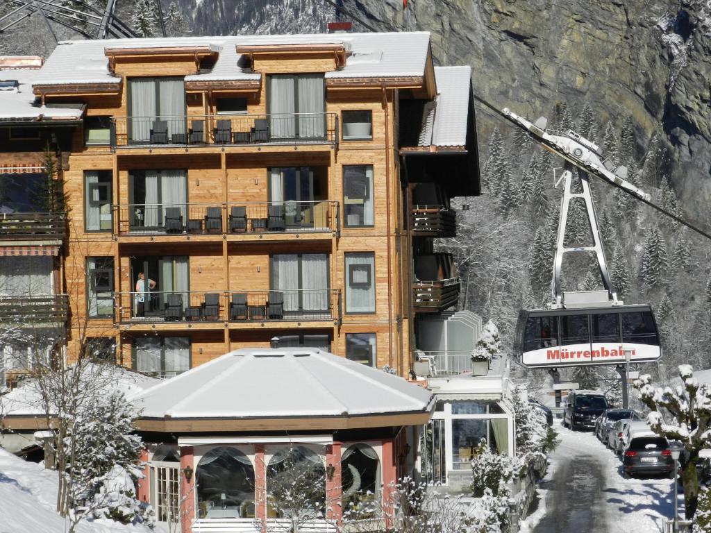 a building in the snow with a tram at Hotel Silberhorn in Lauterbrunnen