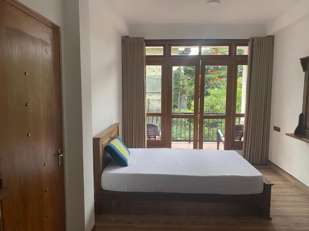 Postel nebo postele na pokoji v ubytování Ella Leafy Homestay