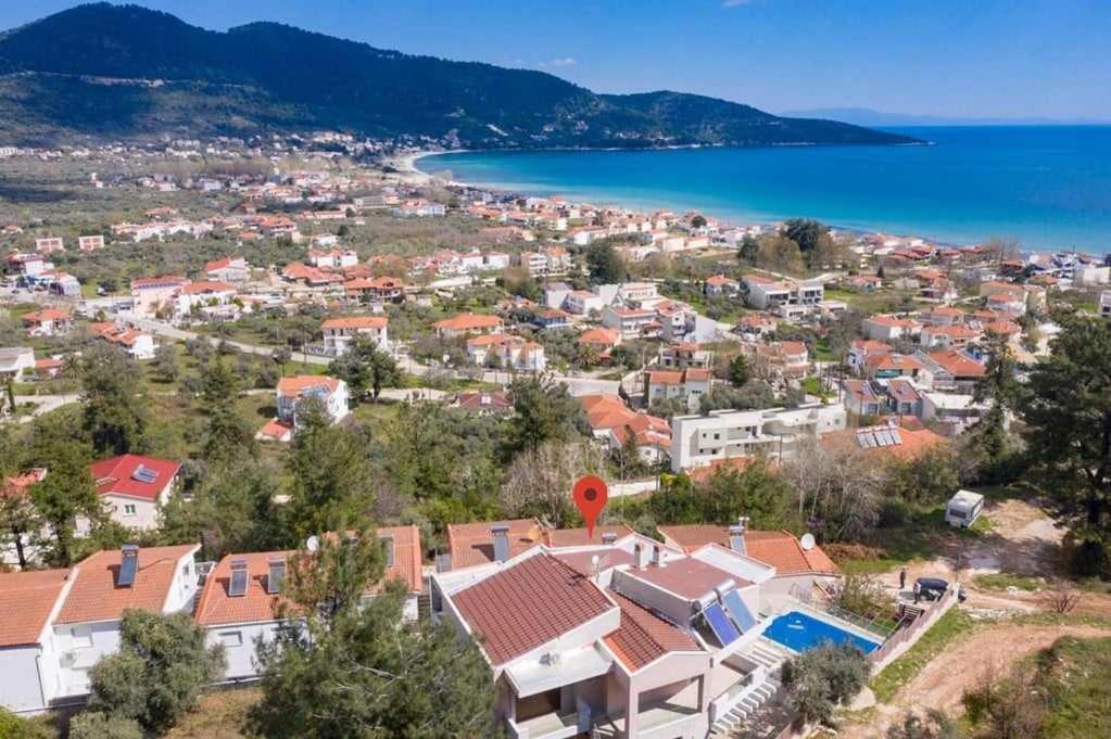 a view of a town with houses and the ocean at Villa Andrea in Skala Potamias