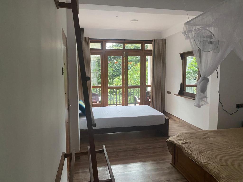Postel nebo postele na pokoji v ubytování Ella Leafy Homestay