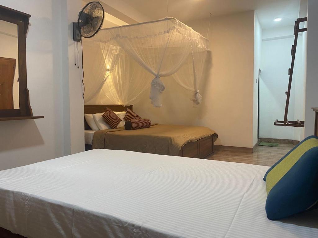 Postel nebo postele na pokoji v ubytování Ella Leafy Homestay
