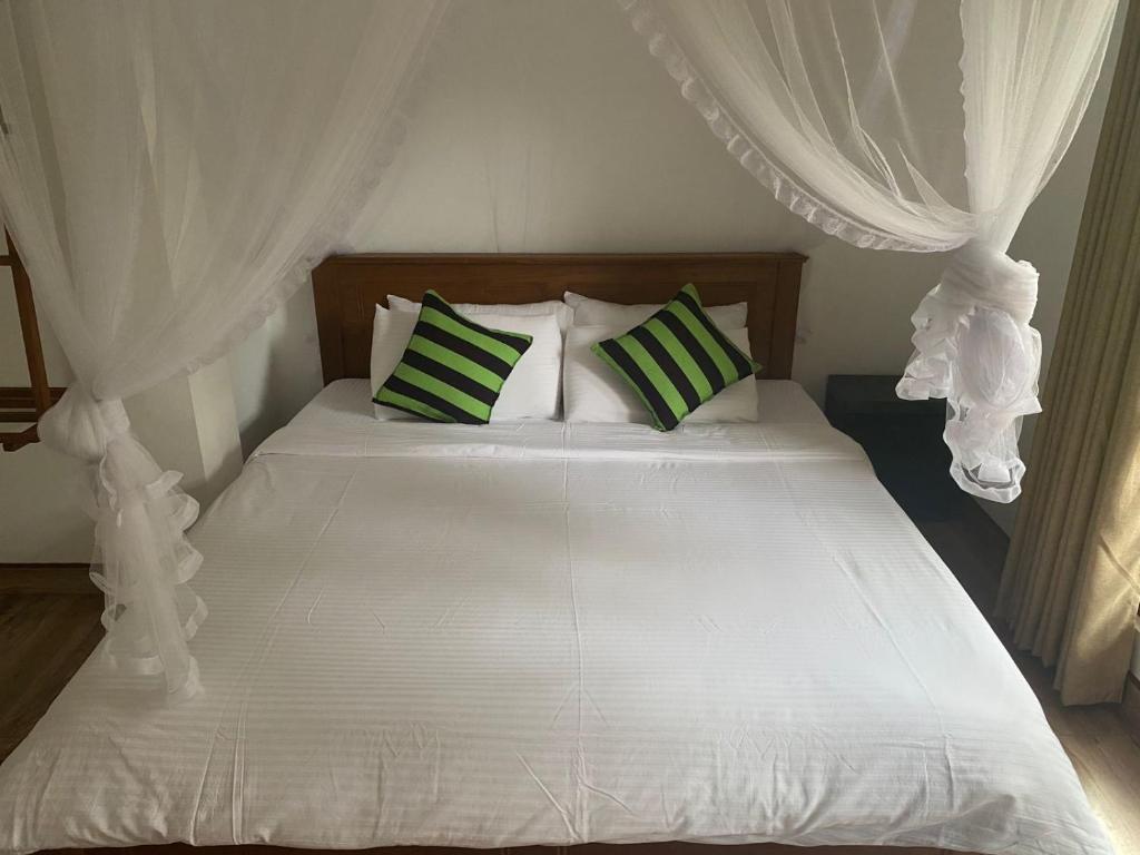 Postel nebo postele na pokoji v ubytování Ella Leafy Homestay