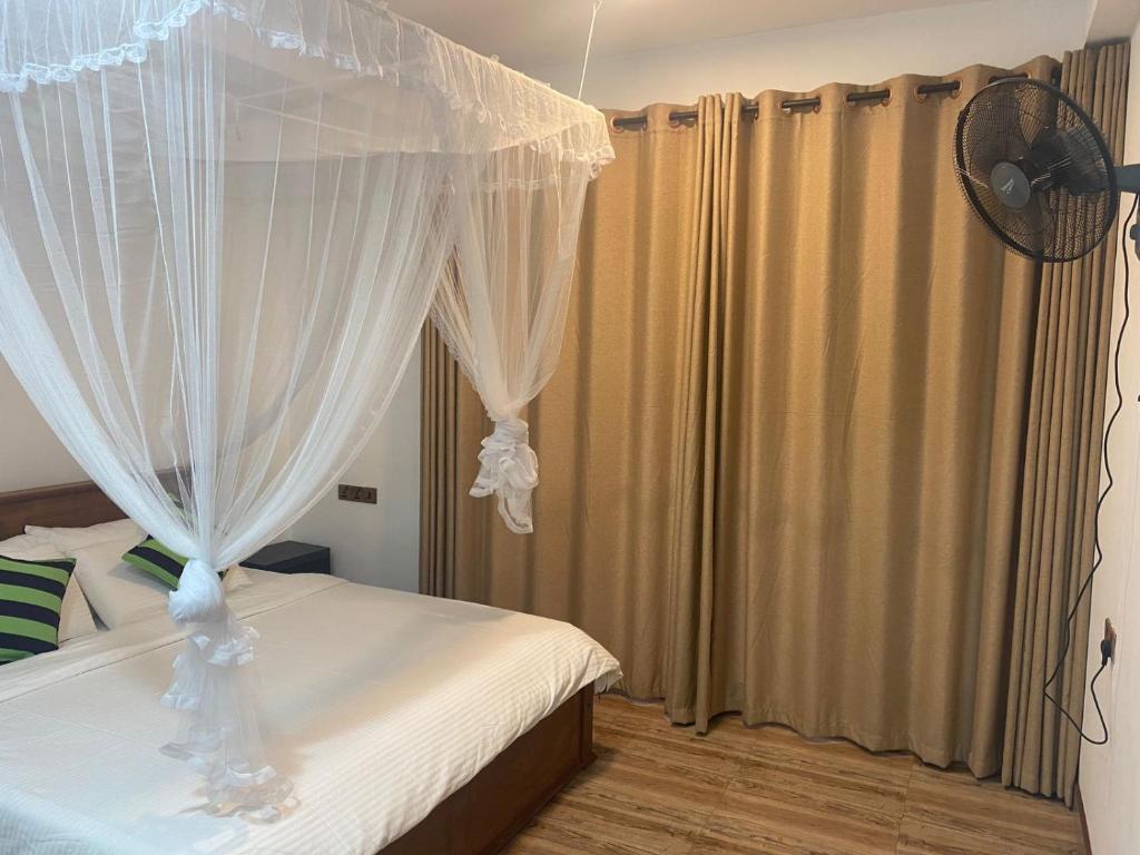 Postel nebo postele na pokoji v ubytování Ella Leafy Homestay