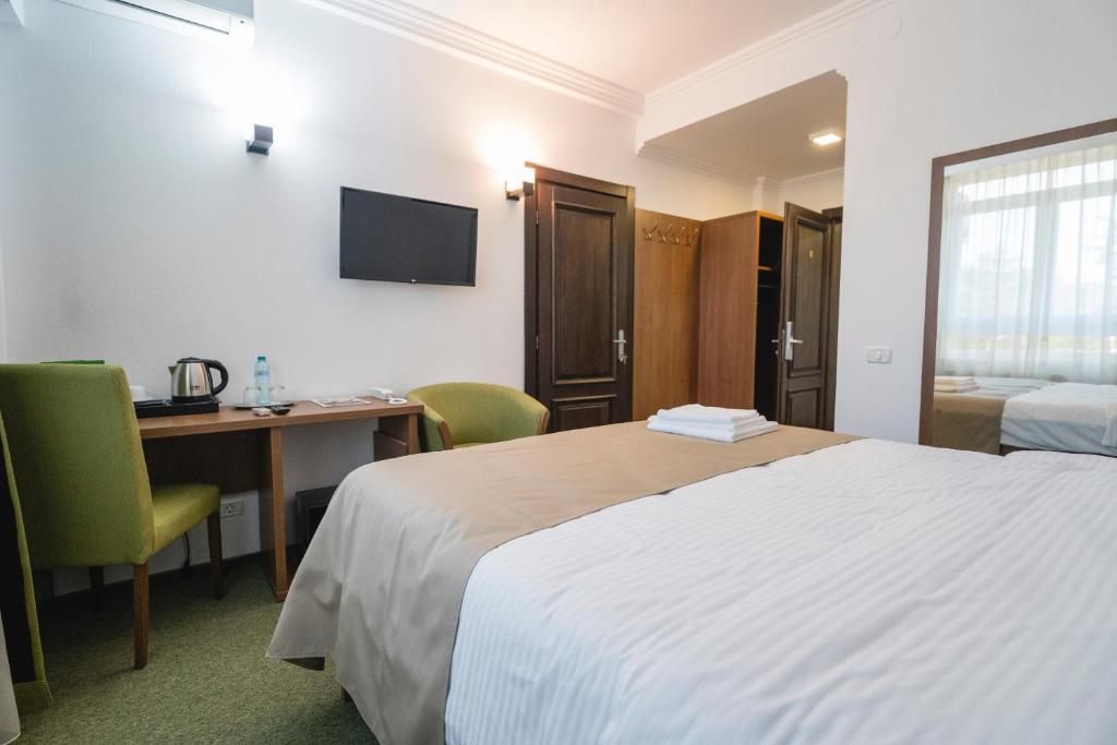 Postel nebo postele na pokoji v ubytování Hotel Comat Deva
