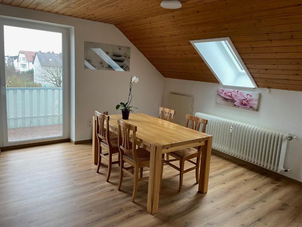 a dining room with a wooden table and chairs at Orchidee in Dinkelsbühl