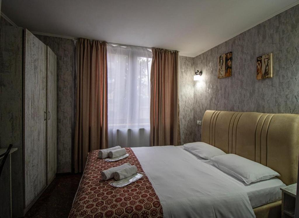 Postel nebo postele na pokoji v ubytování HotelHarmony
