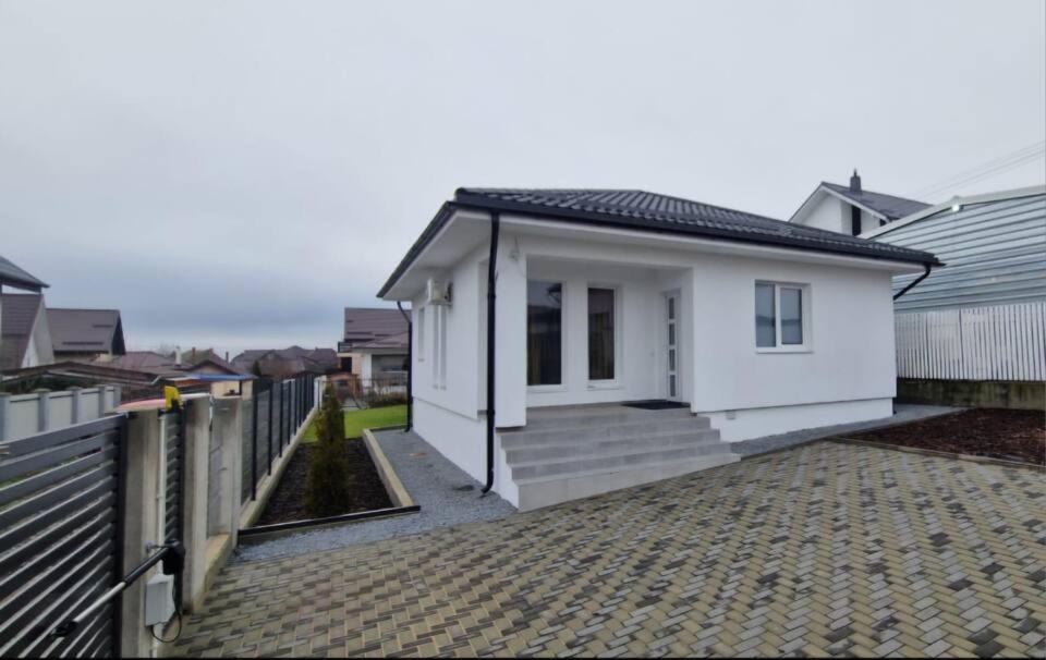 a white house with a fence and a driveway at myHome Residence in Nazna