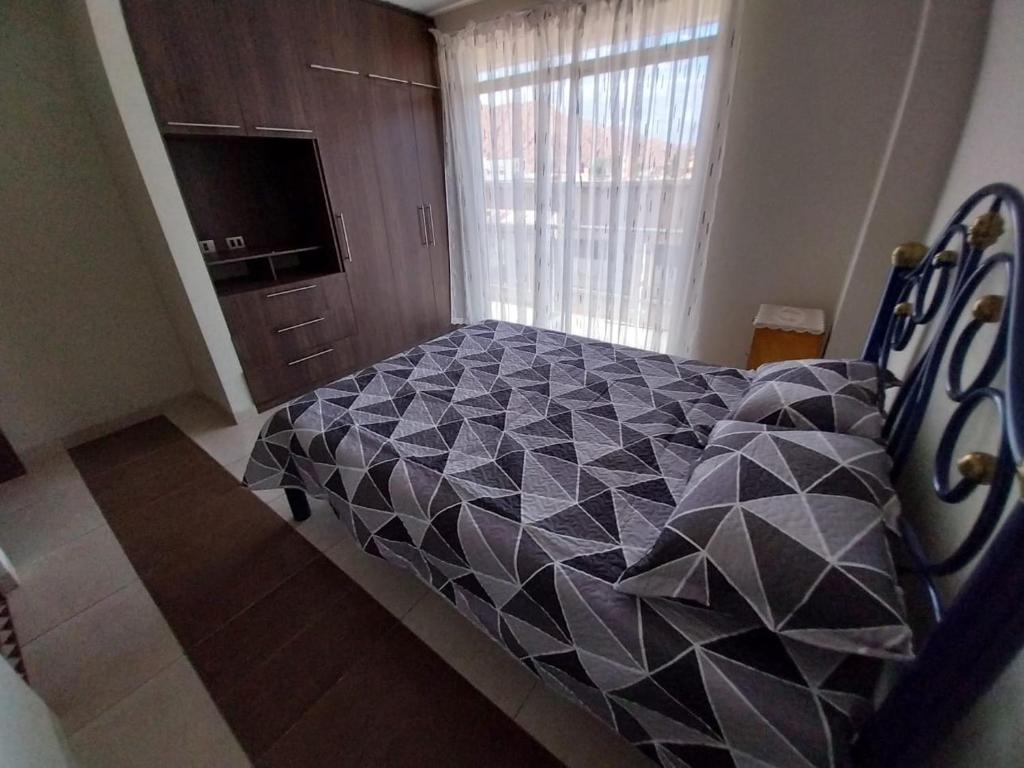 Ένα ή περισσότερα κρεβάτια σε δωμάτιο στο Apartamento Céntrico y Acogedor Tu Hogar lejos de Casa