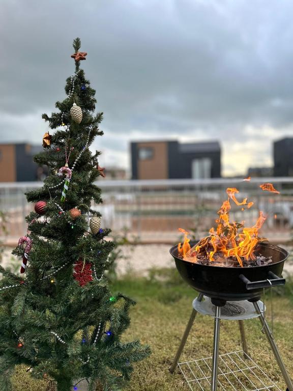 a grill with a christmas tree next to a brazier at Serenity Village Belek in Belek