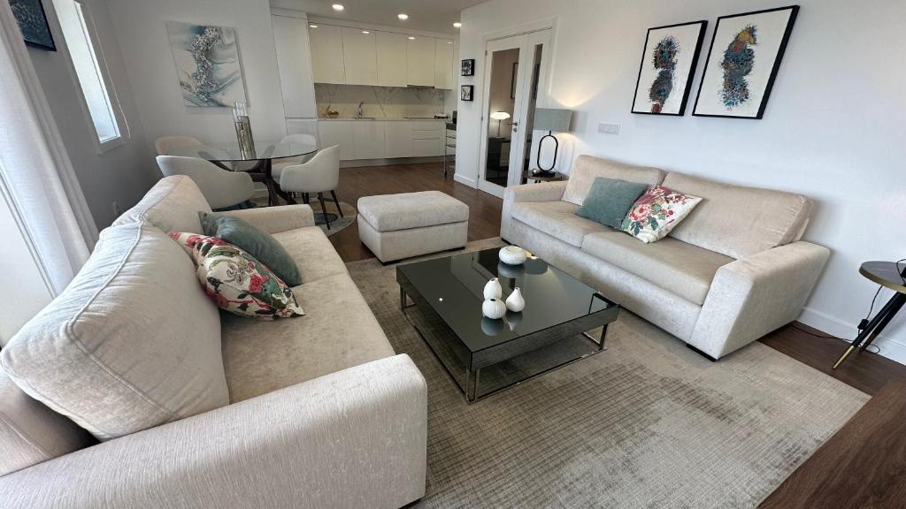 a living room with two couches and a table at River View apartment in Chaves