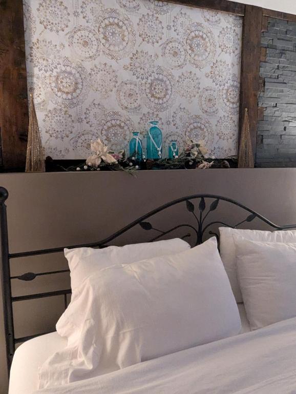 a bed with two glasses on top of it at Suite in the Bush-Private Apartment in Bancroft