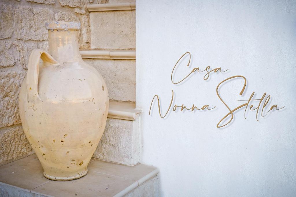 un vase assis sur une étagère à côté d'un mur dans l'établissement Casa Nonna Stella, à Martina Franca