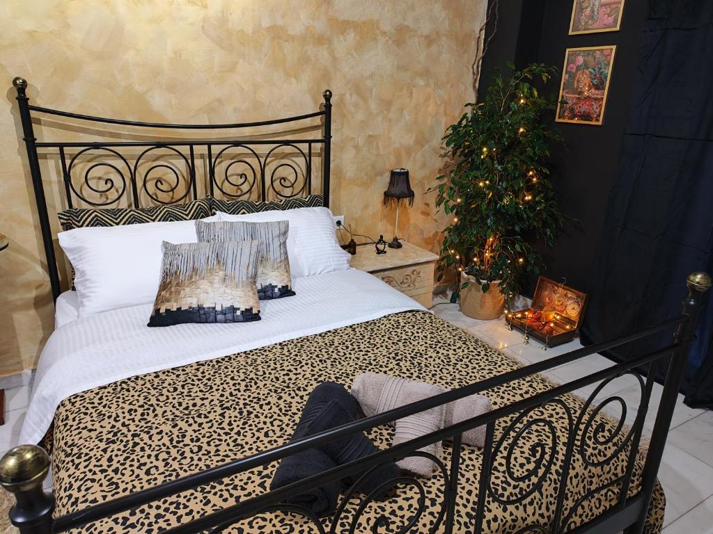 a bedroom with a black and white bed and a christmas tree at Anatolia in Veria