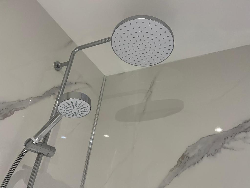 a shower with a shower head in a bathroom at Whitstable The Jolly in Whitstable