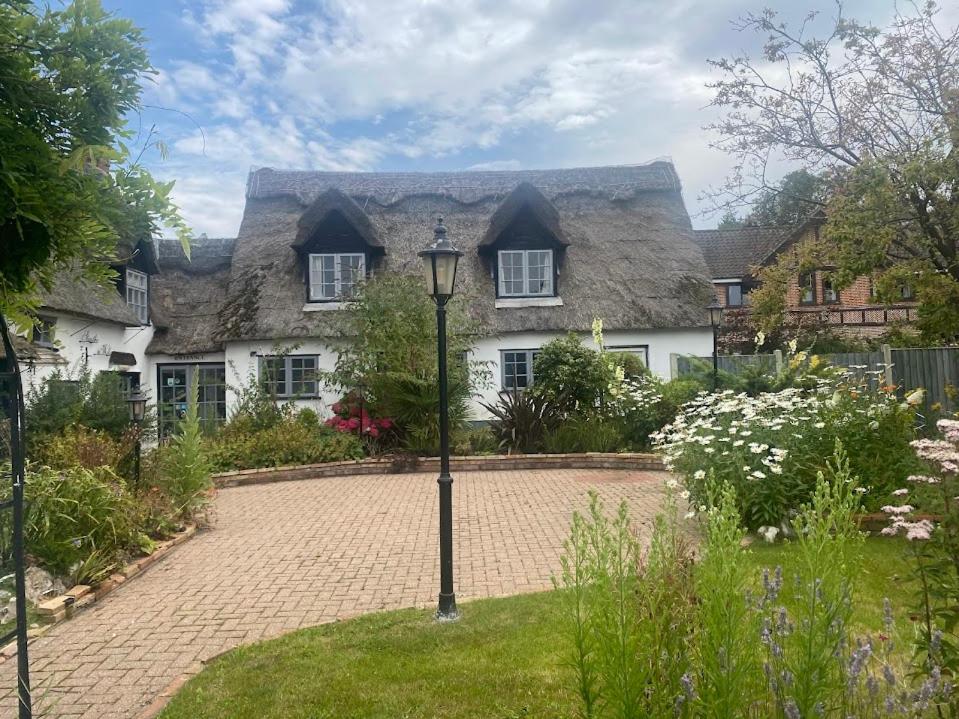 a large house with a thatched roof at Willow Cottage in Horning