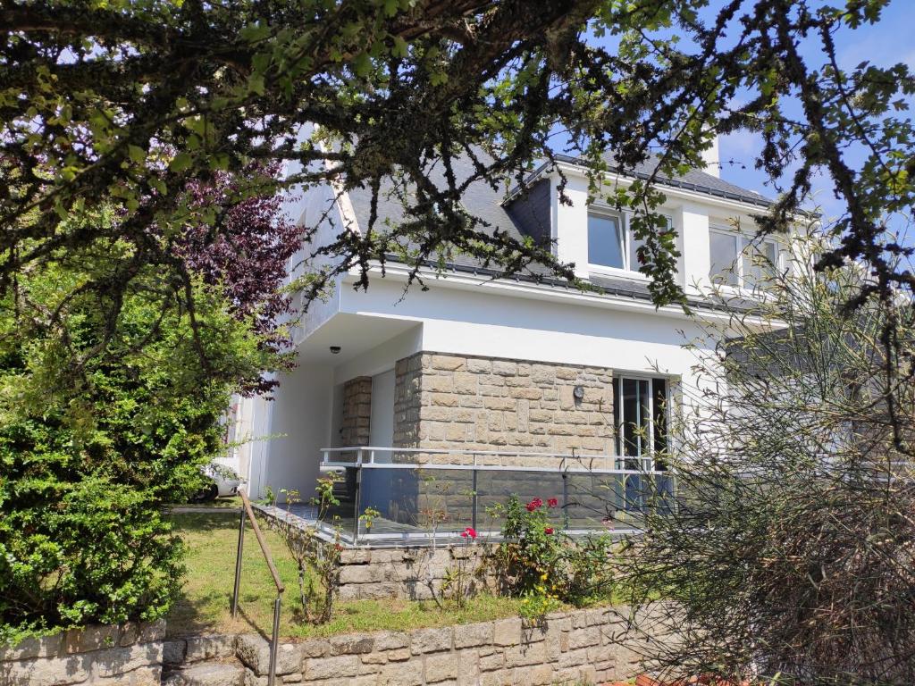 une maison blanche avec une clôture devant dans l'établissement Maison 800 m de la plage pour 9 personnes, à Saint-Gildas-de-Rhuys