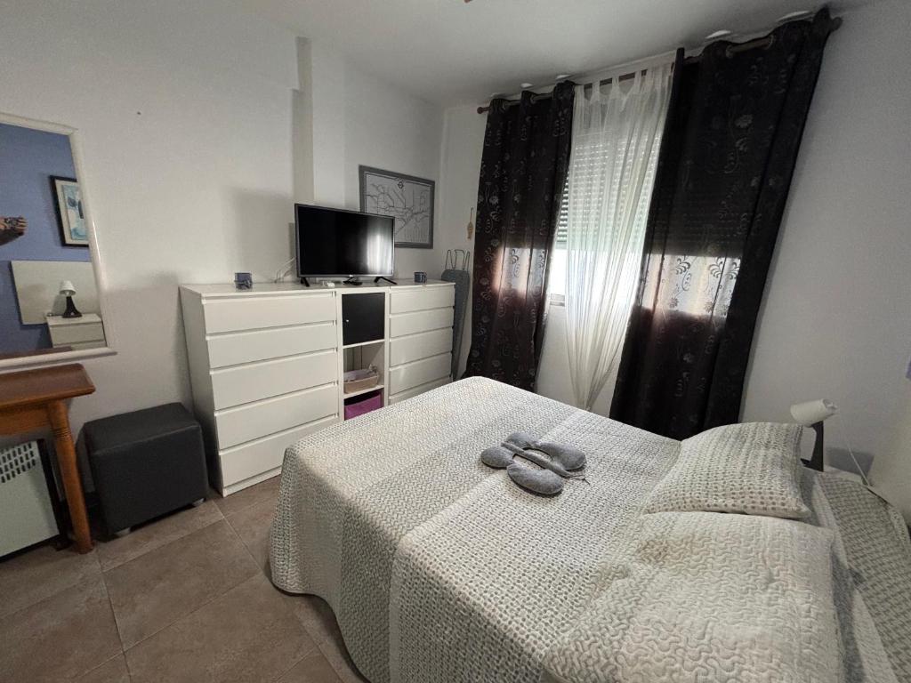 A bed or beds in a room at Faro de Cullera I