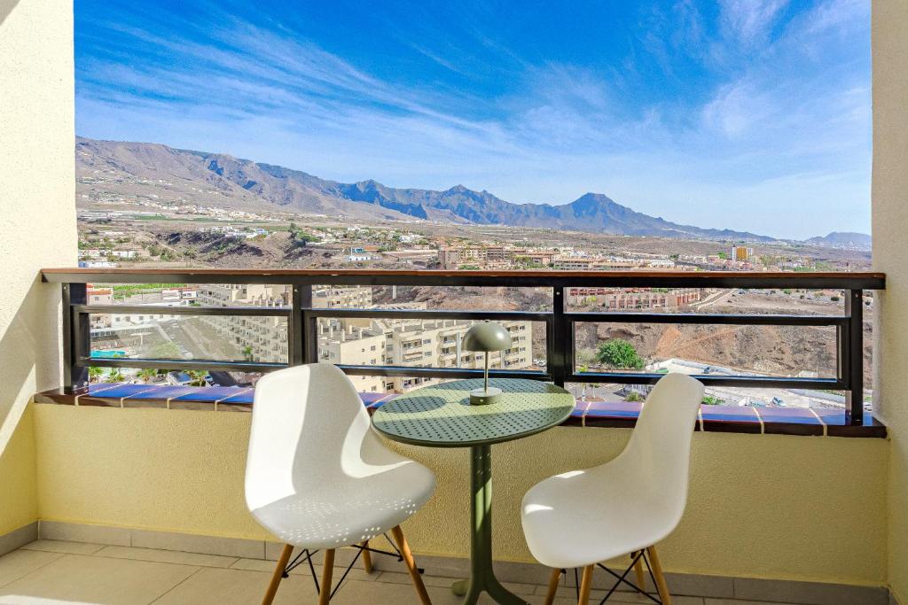 a balcony with a table and two chairs and a view at 14th floor Panoramic View in Adeje