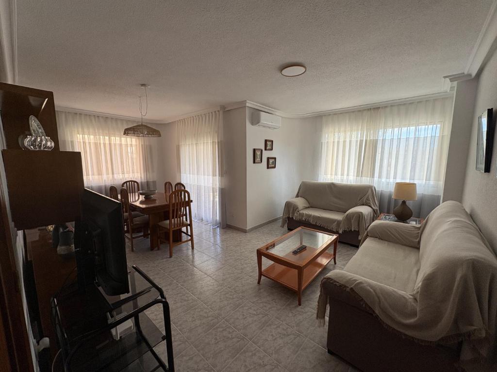 a living room with a couch and a table at Apartamentos La Laguna II in Los Alcázares