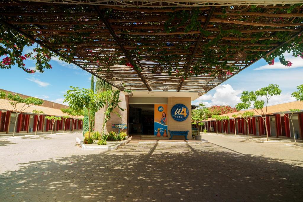 a building with awnings on the side of it at W4 Hotel in Irecê