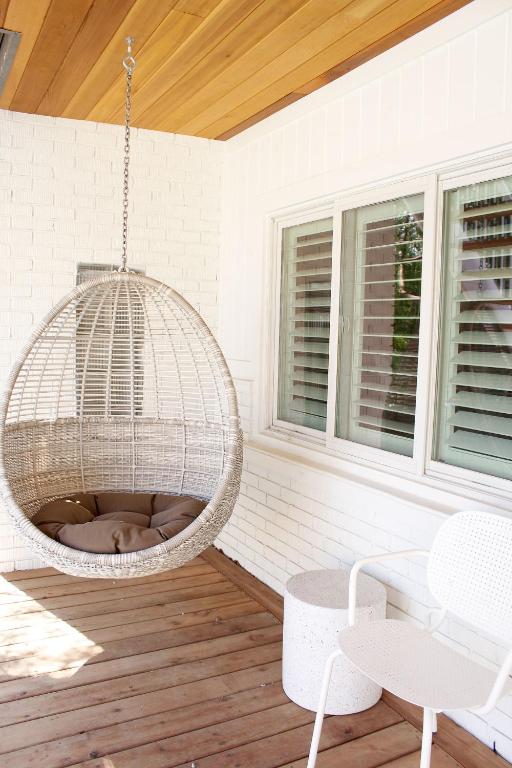 a rattan bird cage hanging from a porch at The Beach Motel in Southampton