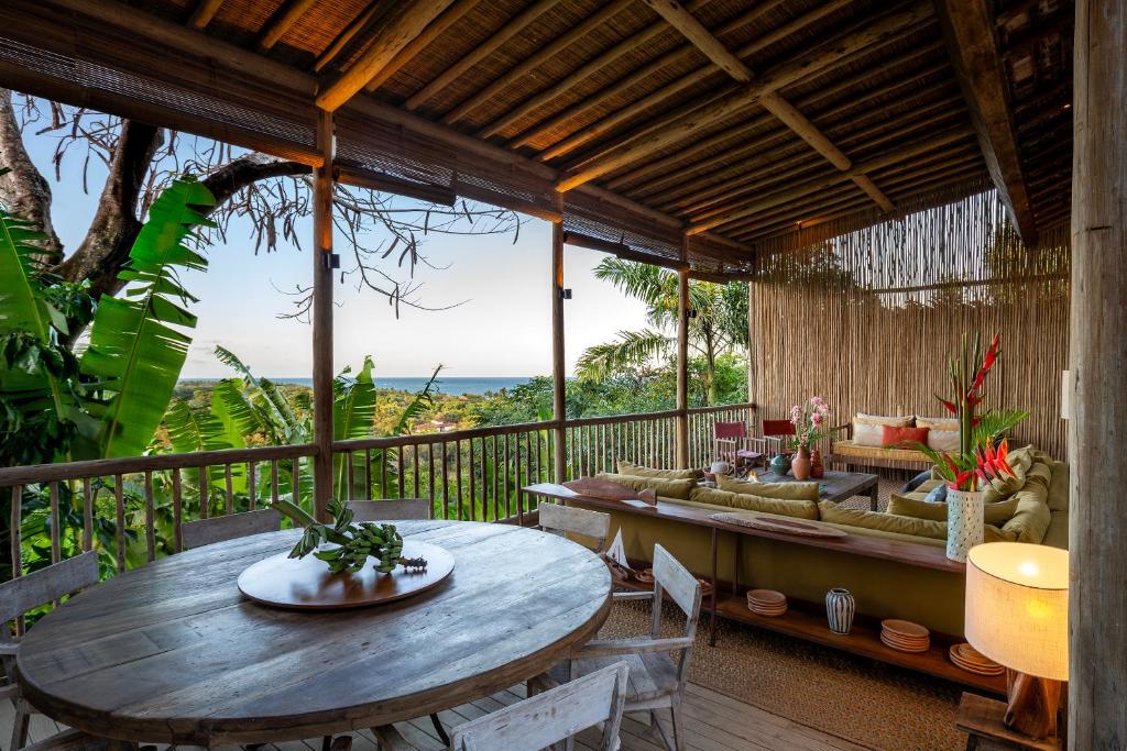 an outdoor patio with a table and a couch at Casa CP, localização incrível em Trancoso, no Quadrado Historico in Porto Seguro