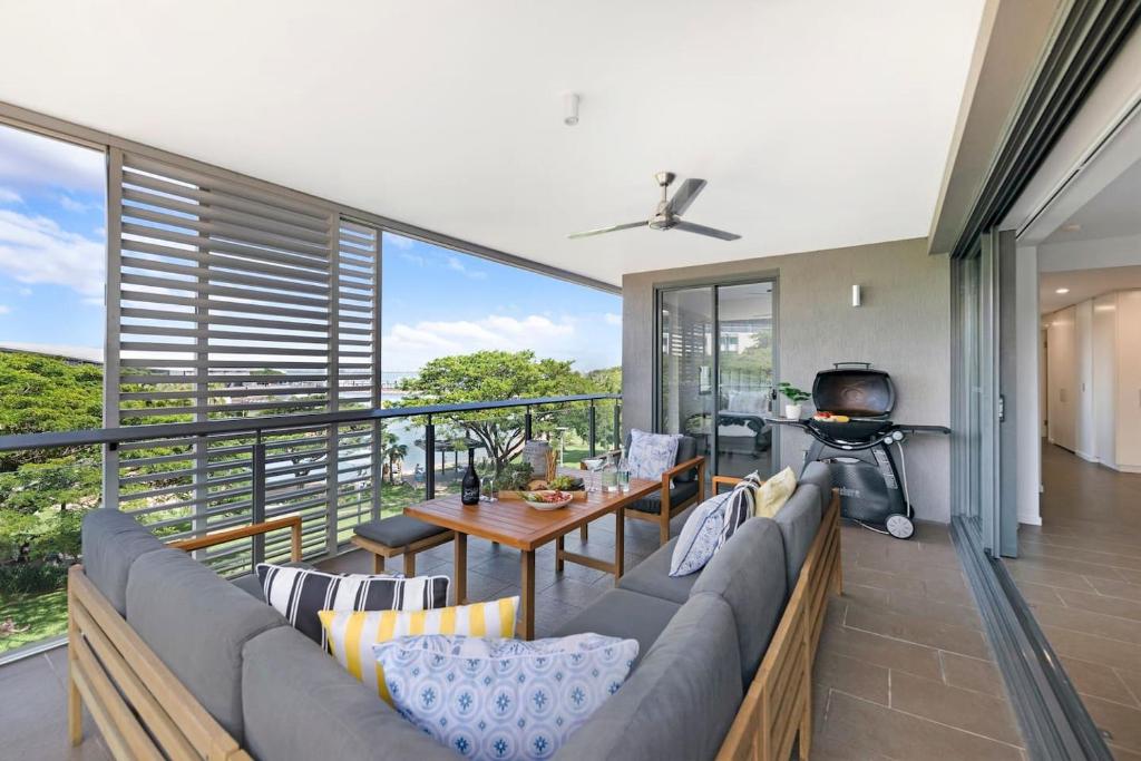 a living room with a couch and a table at Waterfront Bliss - Explore Darwin's Premier Location in Darwin