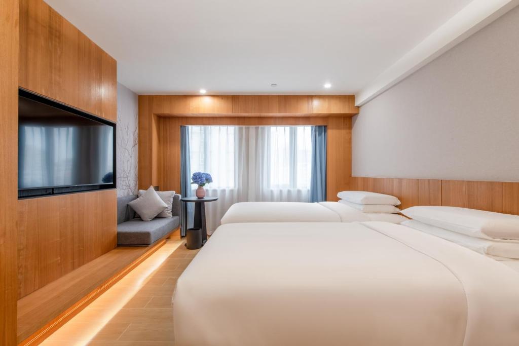 Postel nebo postele na pokoji v ubytování Fairfield by Marriott Guangzhou Tianhe Park