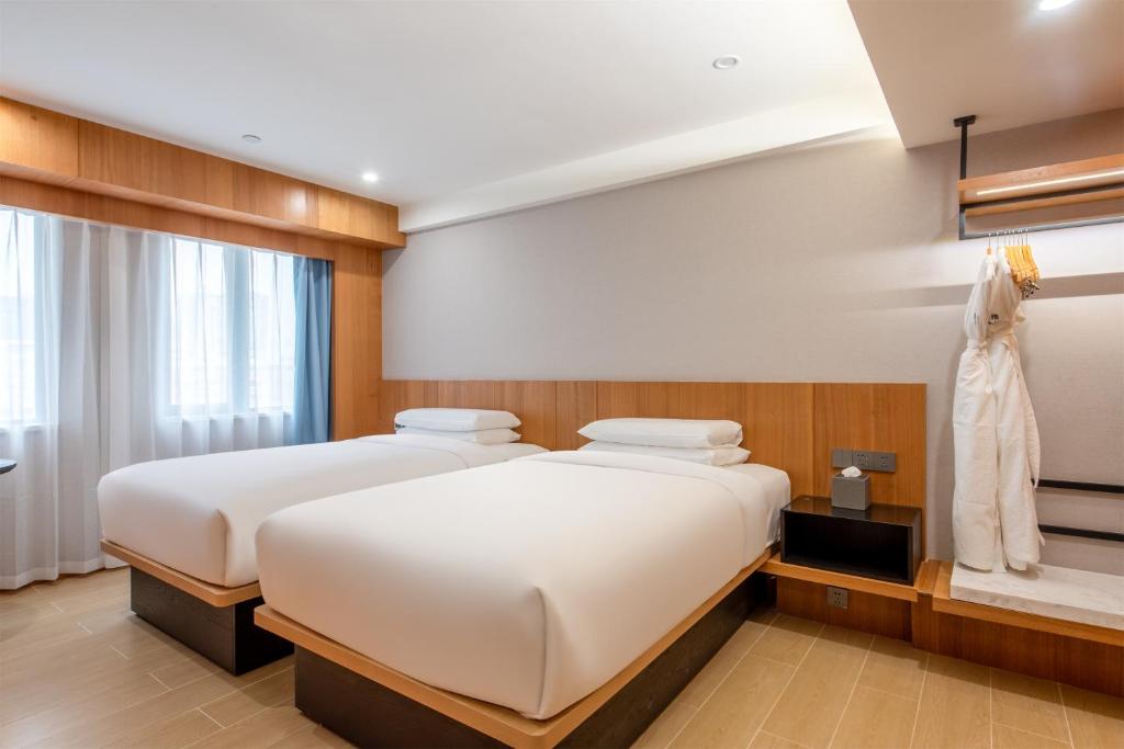 Postel nebo postele na pokoji v ubytování Fairfield by Marriott Guangzhou Tianhe Park