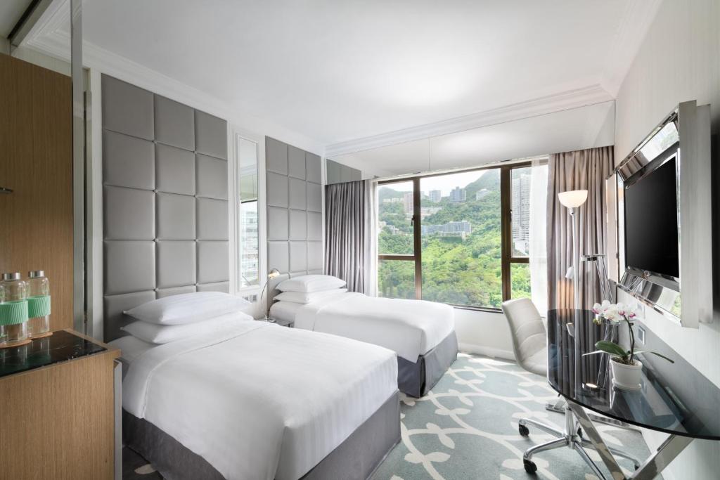 Postel nebo postele na pokoji v ubytování Dorsett Wanchai, Hong Kong