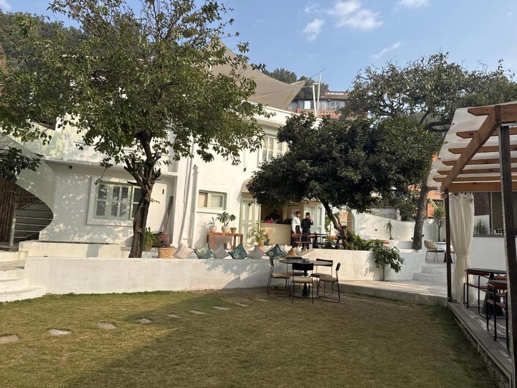 a backyard of a house with a table and chairs at Roommates by MaybeMars in Kathmandu