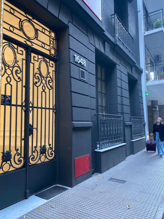 a black building with a large gate on the side of it at Vizion Juncal- Encanto francés en el corazón de Recoleta- Wifi alta velocidad-Seguridad 24 horas in Buenos Aires