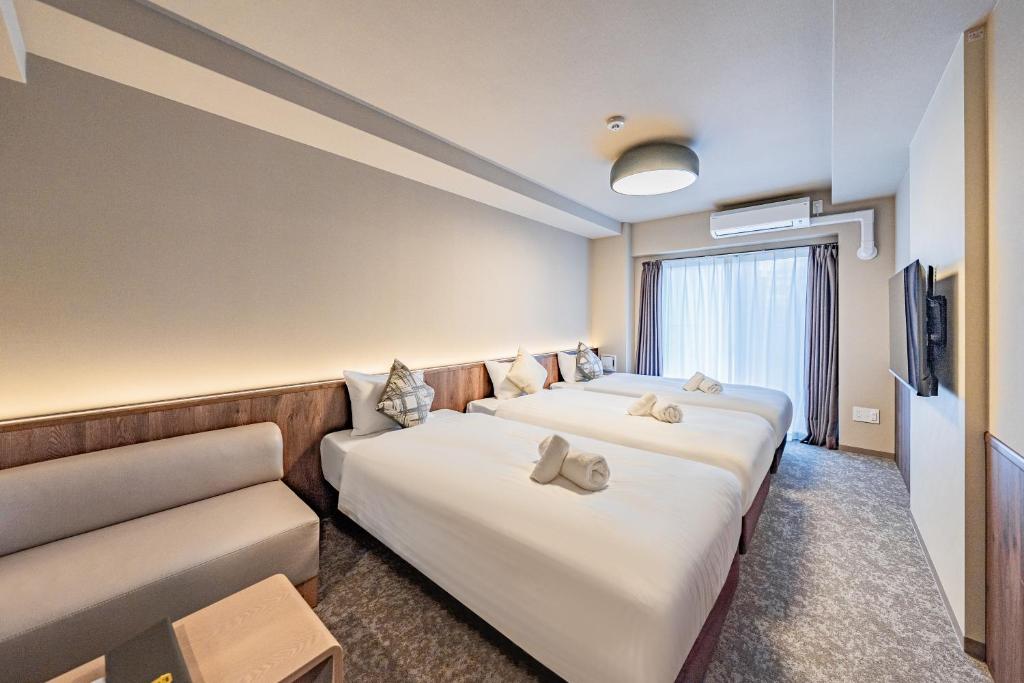 Postel nebo postele na pokoji v ubytování Apartment Hotel 11 Tsutenkaku