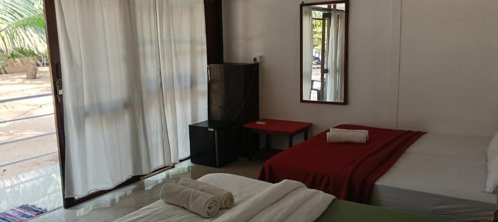 Postel nebo postele na pokoji v ubytování Casa Beach hut Resort