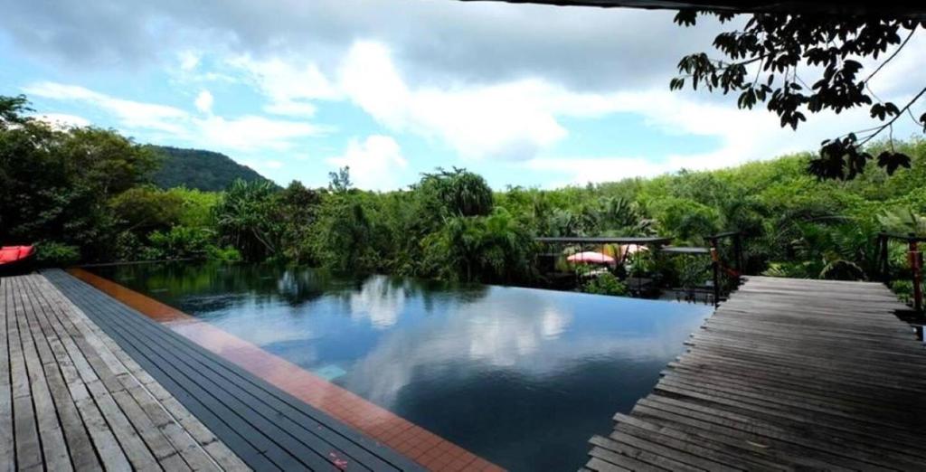 a swimming pool in the middle of a river at 05 - Exquisite Paradise Retreat in Nai Thon Beach