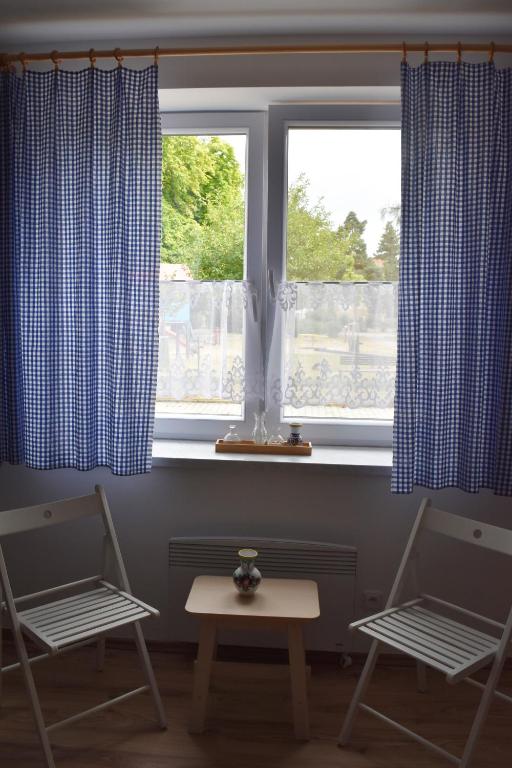 two chairs and a table in front of a window at Ubytování u vinaře in Břeclav