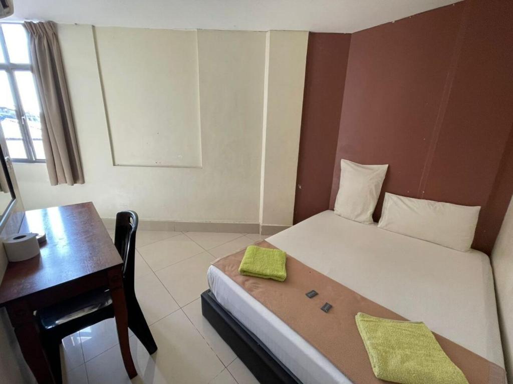 Postel nebo postele na pokoji v ubytování SV Andalas Hotel