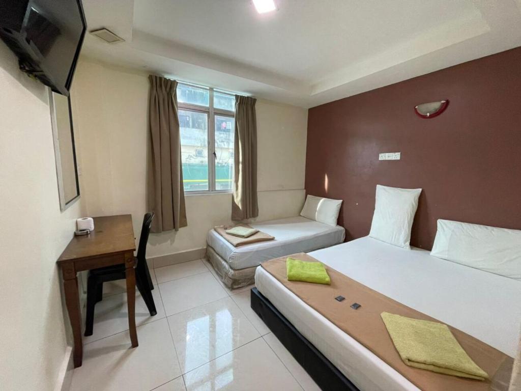 Postel nebo postele na pokoji v ubytování SV Andalas Hotel